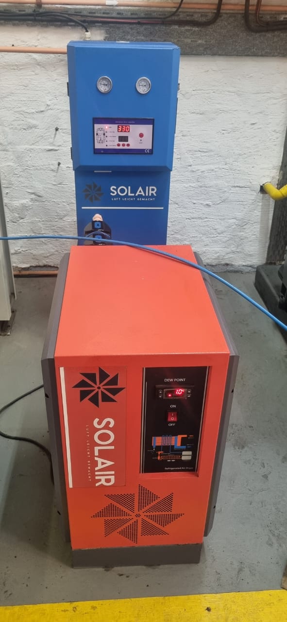 A wall-mounted Solair refrigerated air dryer with a digital dew point display, installed by GP Compressors to provide clean, dry air.